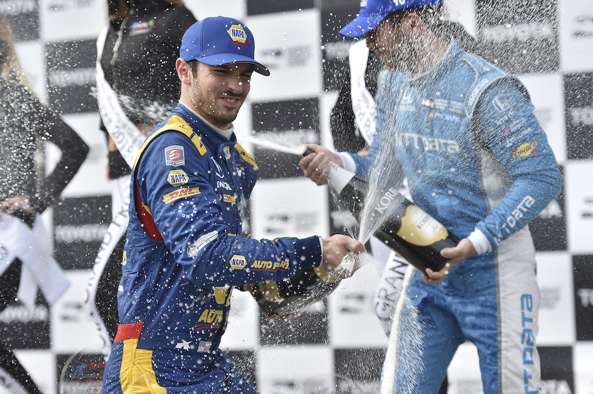 Alexander Rossi sprays the champagne in Victory Circle after winning the Toyota Grand Prix of Long Beach