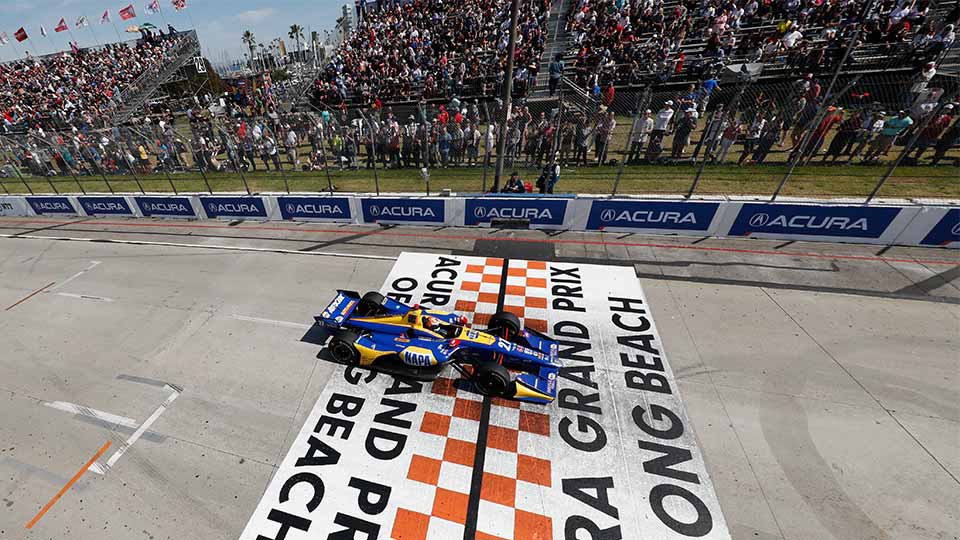 Alexander Rossi races over the finish line at the acura grand prix of long beach