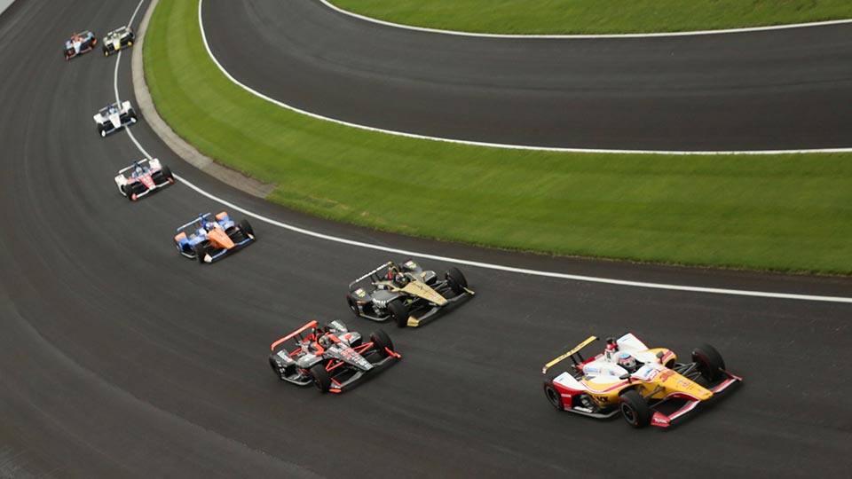 Indy cars race on track