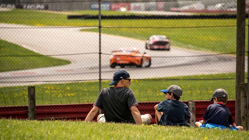 Father and sons enjoying a day at the track