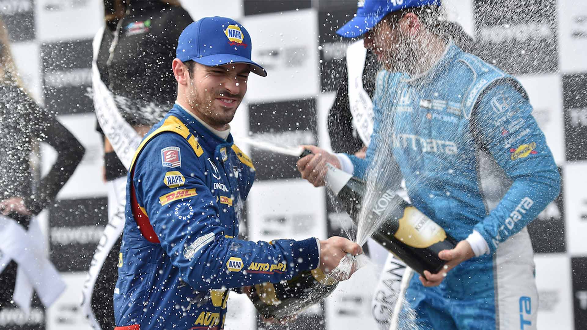 Alexander Rossi sprays the champagne in Victory Circle after winning the Toyota Grand Prix of Long Beach